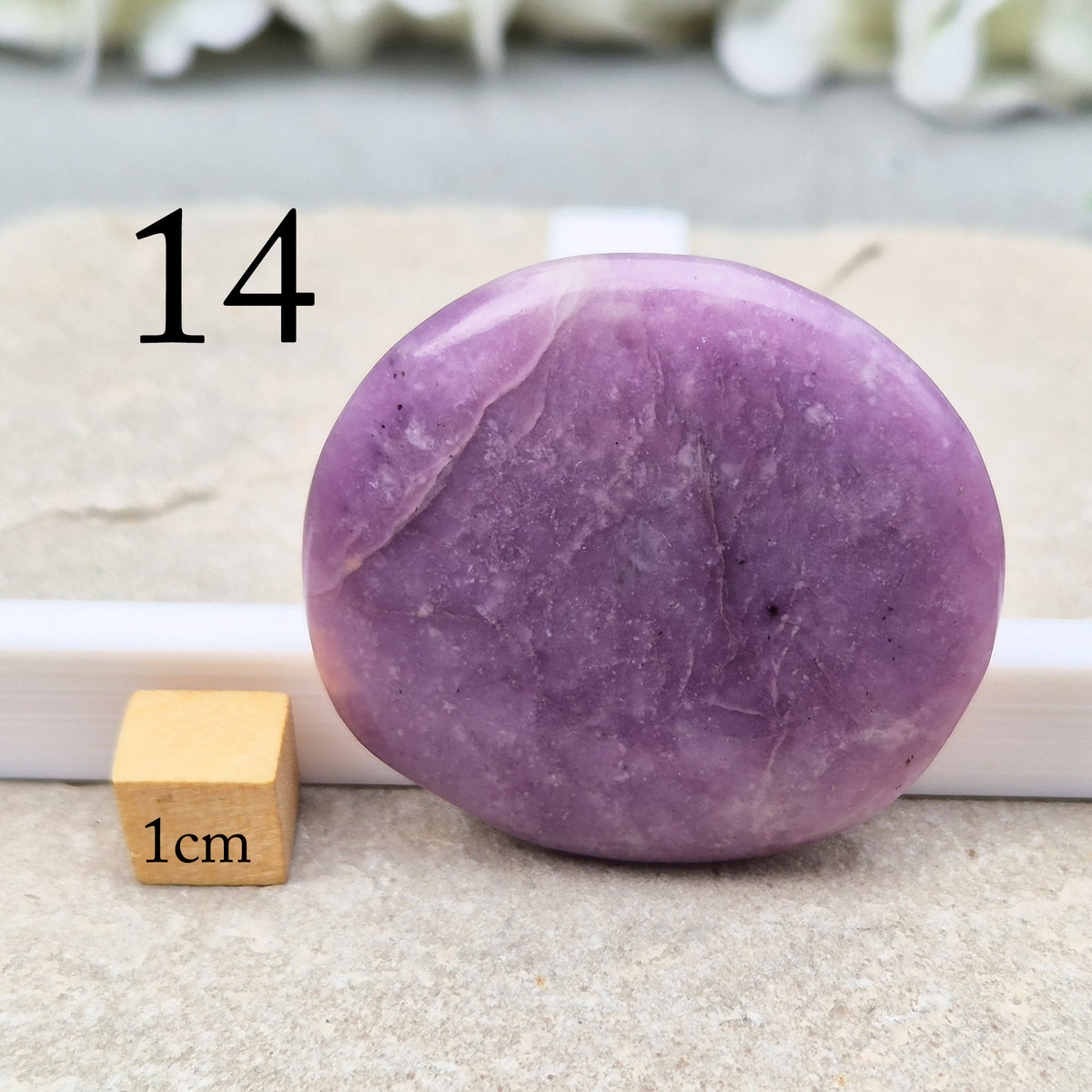 Lepidolite palm stone with calming, balancing energy. Known for easing stress and emotional overwhelm. Smooth, soothing, and ideal for daily support.