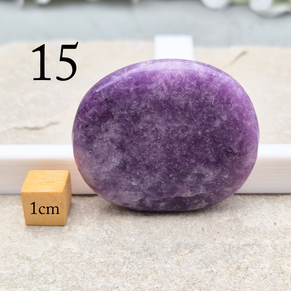 Lepidolite palm stone with calming, balancing energy. Known for easing stress and emotional overwhelm. Smooth, soothing, and ideal for daily support.