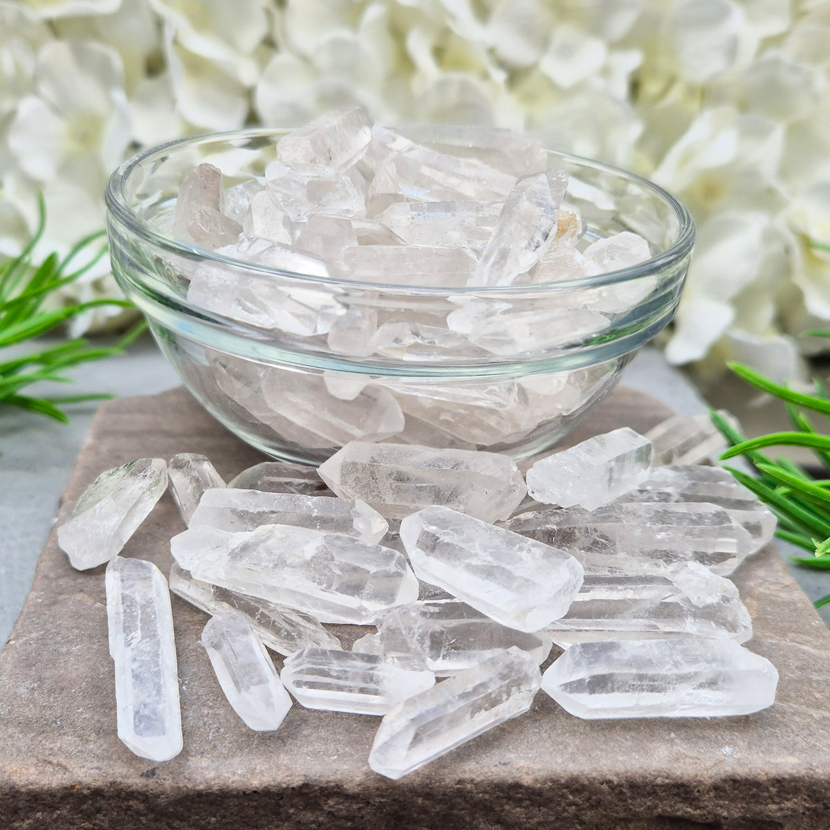 Shop natural mini clear quartz points, 100g of assorted sizes. Known for clarity, focus and amplifying intention — perfect starter crystals or thoughtful gifts.