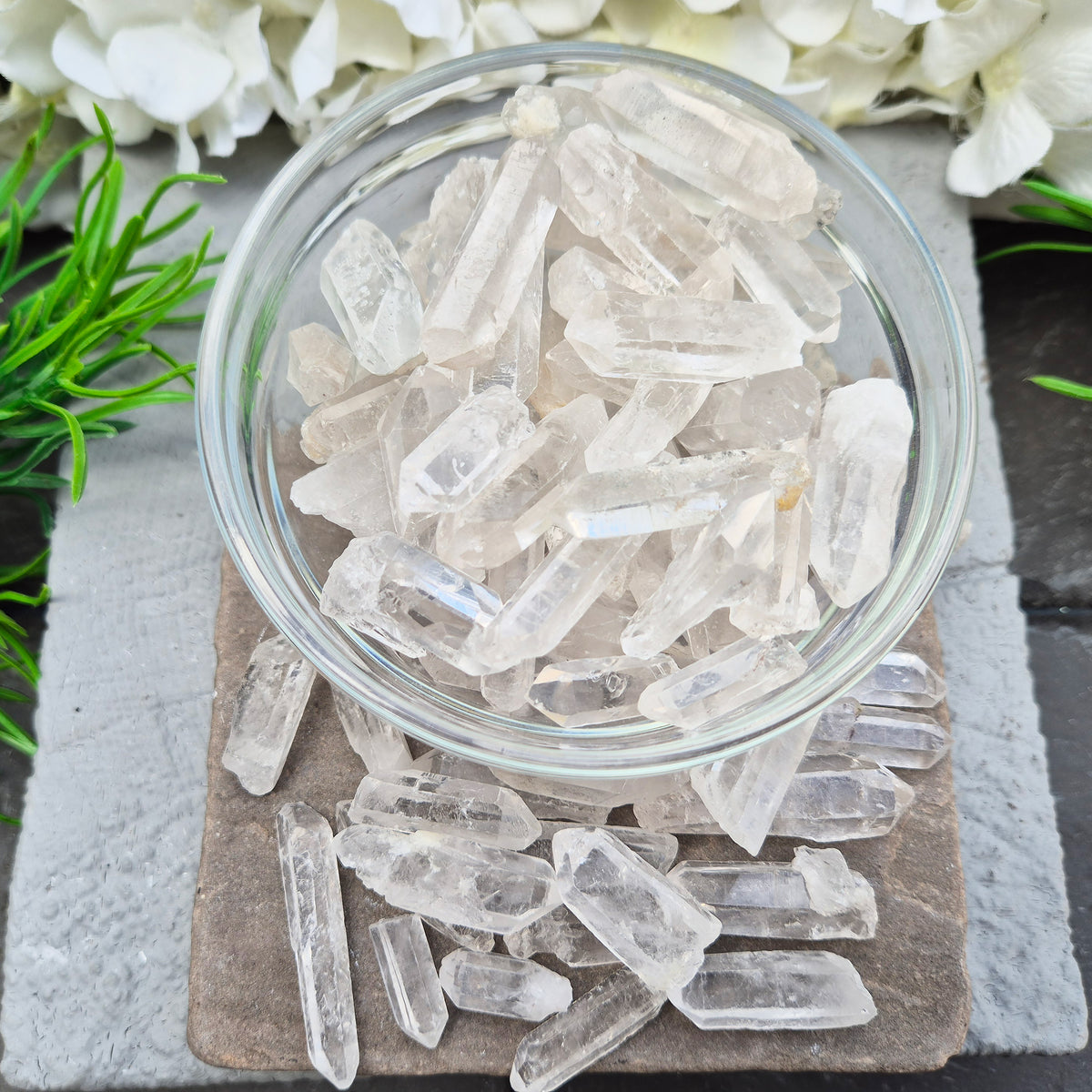 Shop natural mini clear quartz points, 100g of assorted sizes. Known for clarity, focus and amplifying intention — perfect starter crystals or thoughtful gifts.