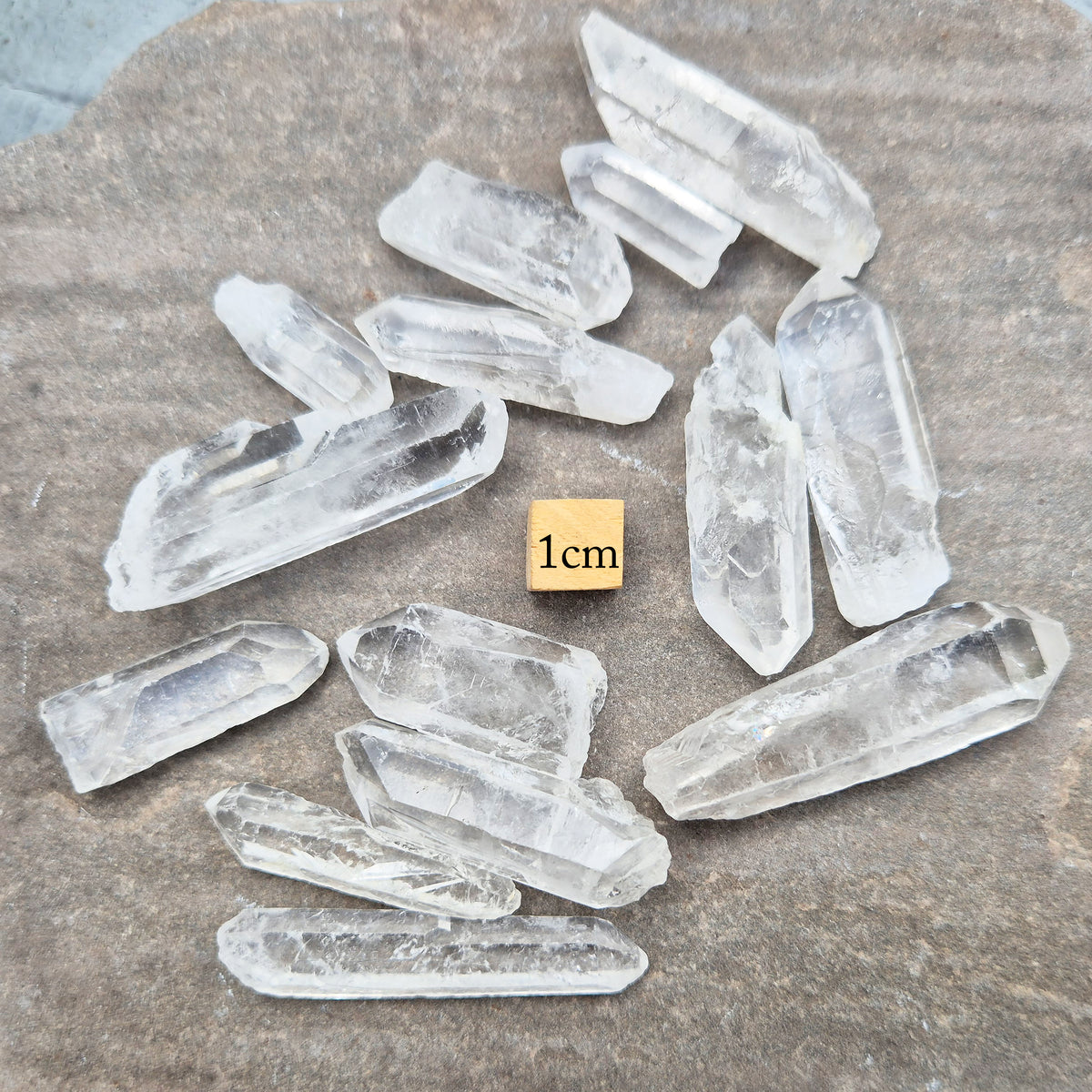 Shop natural mini clear quartz points, 100g of assorted sizes. Known for clarity, focus and amplifying intention — perfect starter crystals or thoughtful gifts.