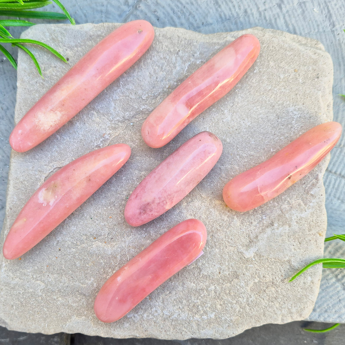 Shop a polished Pink Opal wand in soft, milky pink. Often associated with gentle heart energy and emotional comfort. 