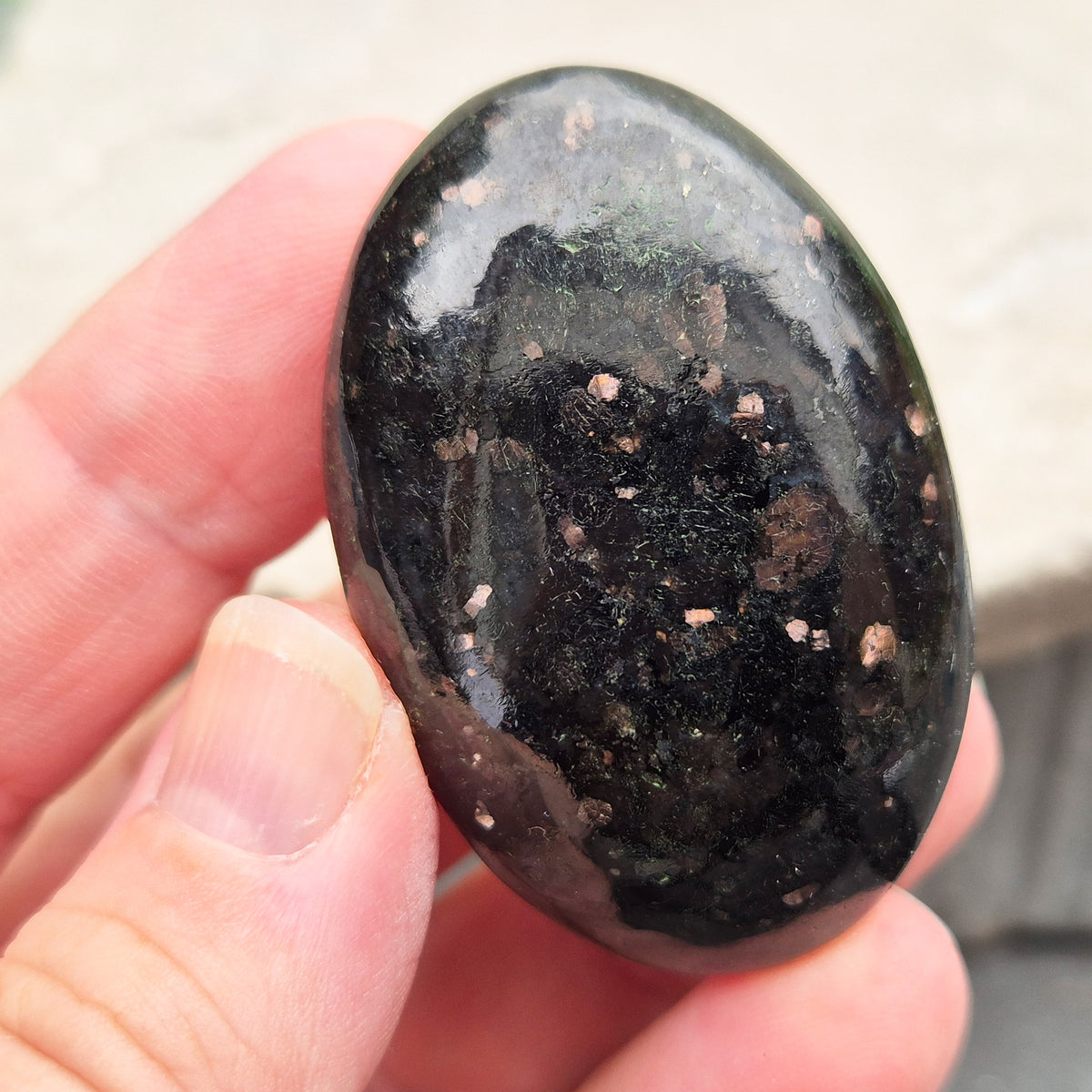 Genuine Nuummite palm stone from Greenland, known as the Sorcerer's Stone. Often associated with protection, intuition, courage and clearing blockages.