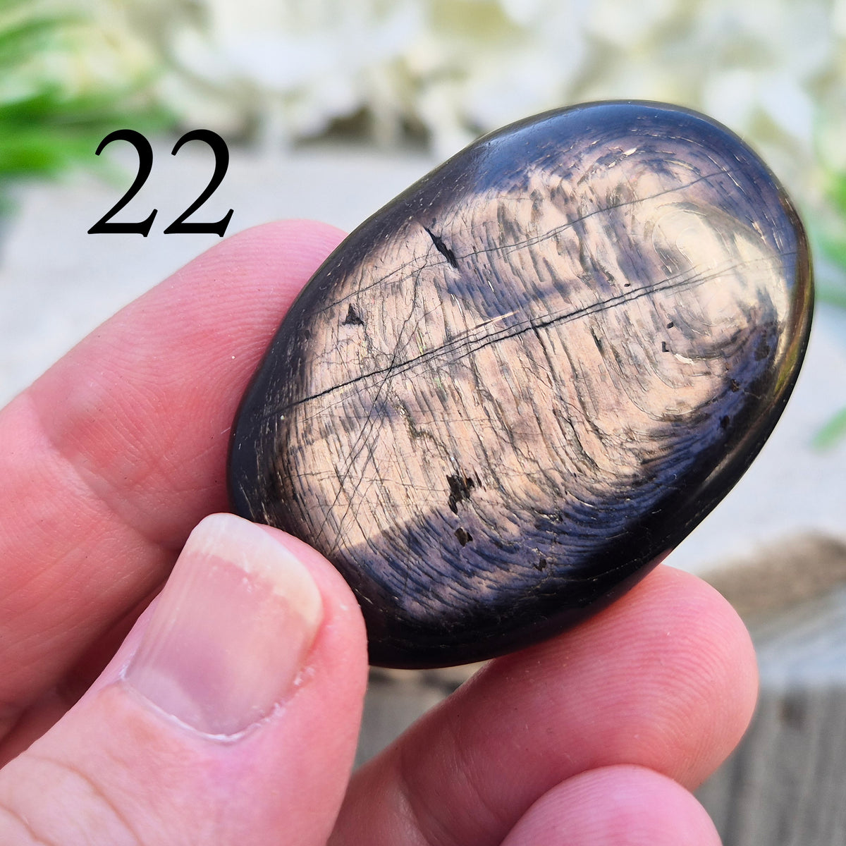 Violet Hypersthene palm stone with a smooth, comforting feel. A grounding crystal often chosen for inner strength, calm focus, and quiet self-reflection.