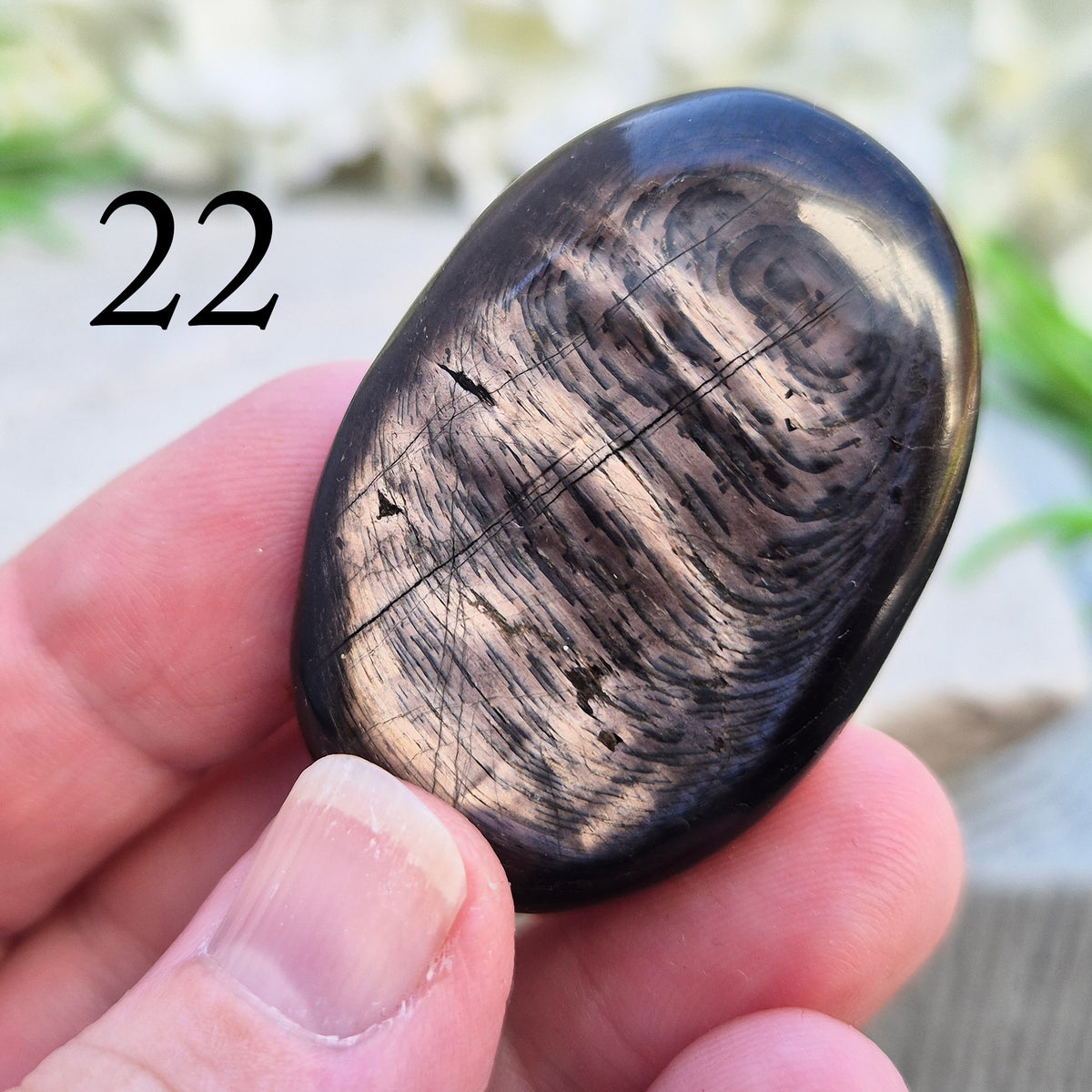 Violet Hypersthene palm stone with a smooth, comforting feel. A grounding crystal often chosen for inner strength, calm focus, and quiet self-reflection.