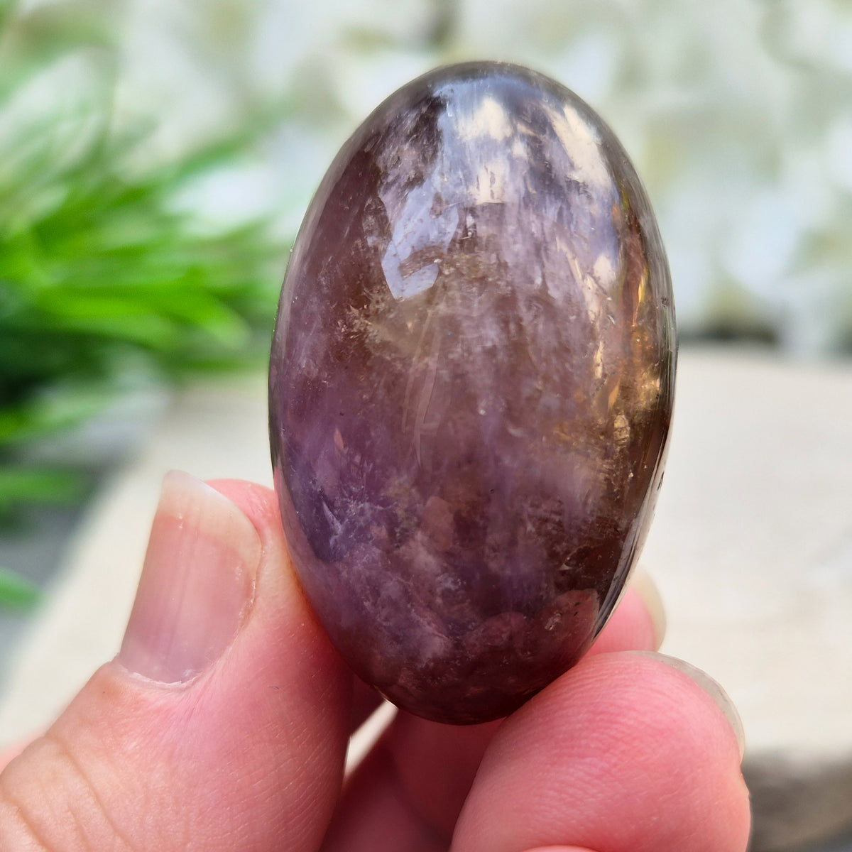 Ametrine polished palm stone with soft purple and golden tones. A natural blend of Amethyst and Citrine with a balanced, easy feel.