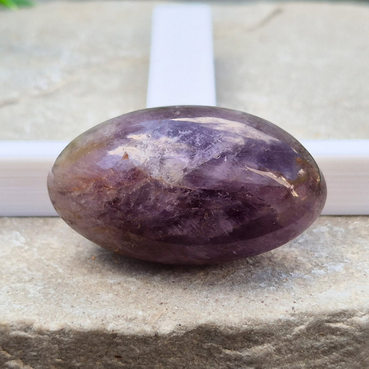 Ametrine polished palm stone with soft purple and golden tones. A natural blend of Amethyst and Citrine with a balanced, easy feel.
