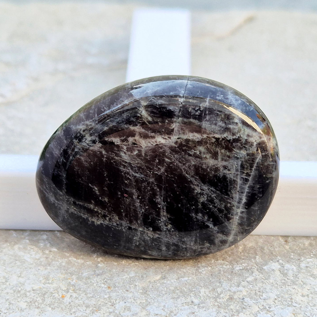 Black Moonstone Palm Stone, valued for its connection to the moon’s energy. Perfect for enhancing intuition, emotional healing, and balancing energy.