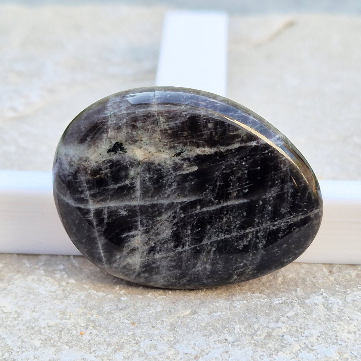 Black Moonstone Palm Stone, valued for its connection to the moon’s energy. Perfect for enhancing intuition, emotional healing, and balancing energy.
