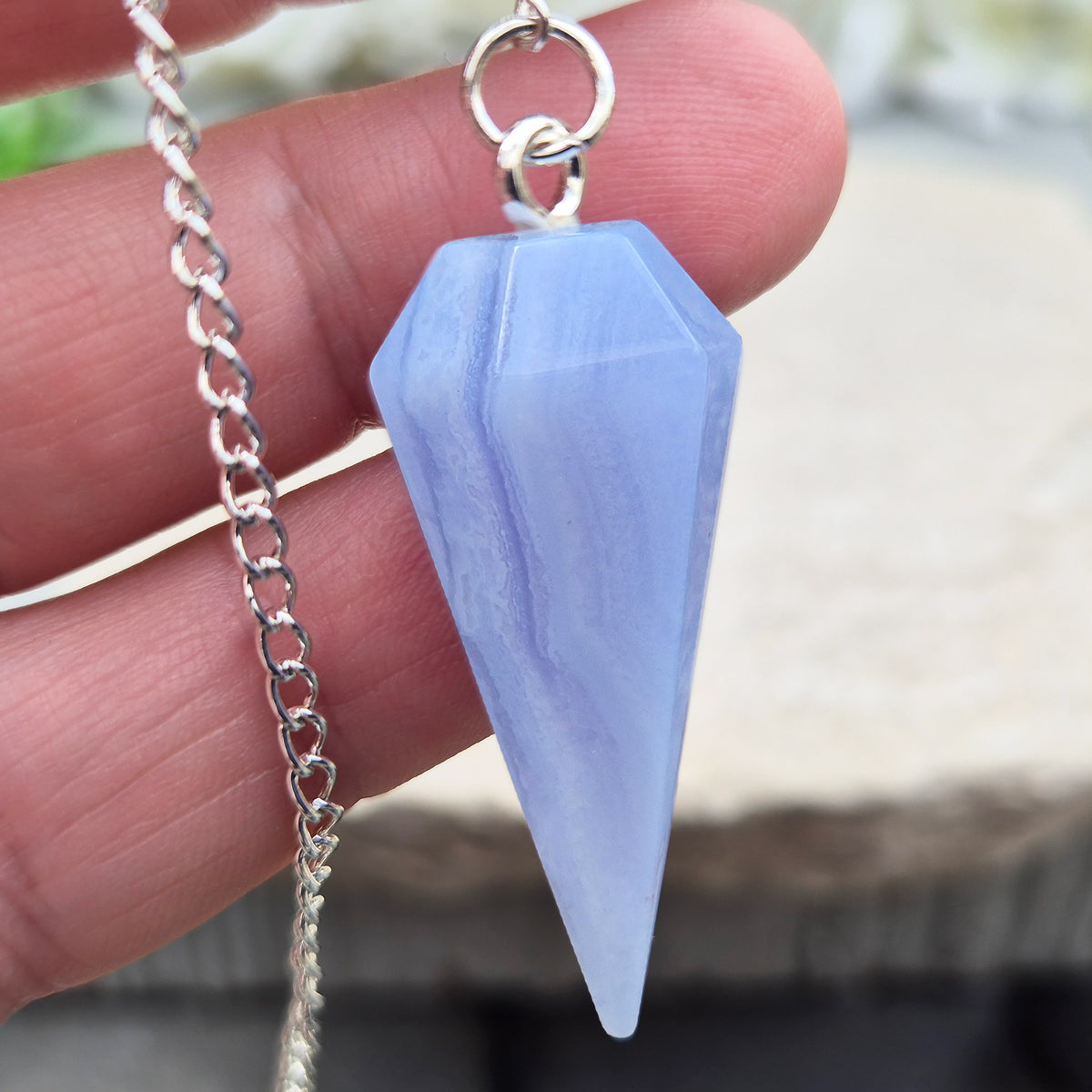 Blue Lace Agate crystal pendulum, known for its calming energy. Ideal for dowsing, spiritual guidance, and bringing a steady, peaceful feel.
