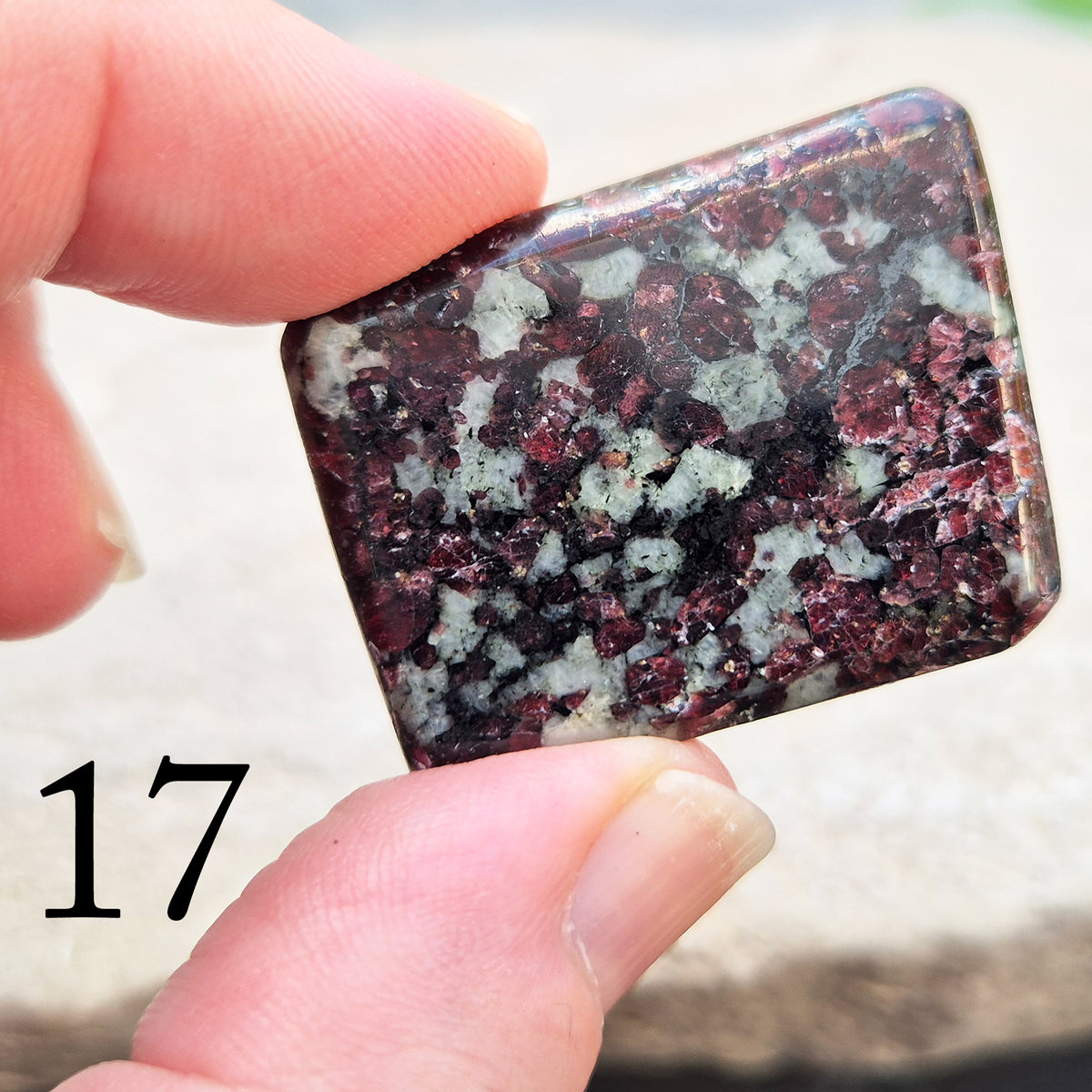 Hand-picked polished eudialyte slice with raspberry-pink and natural black and grey patterning. Often reached for heart-centred meditation.