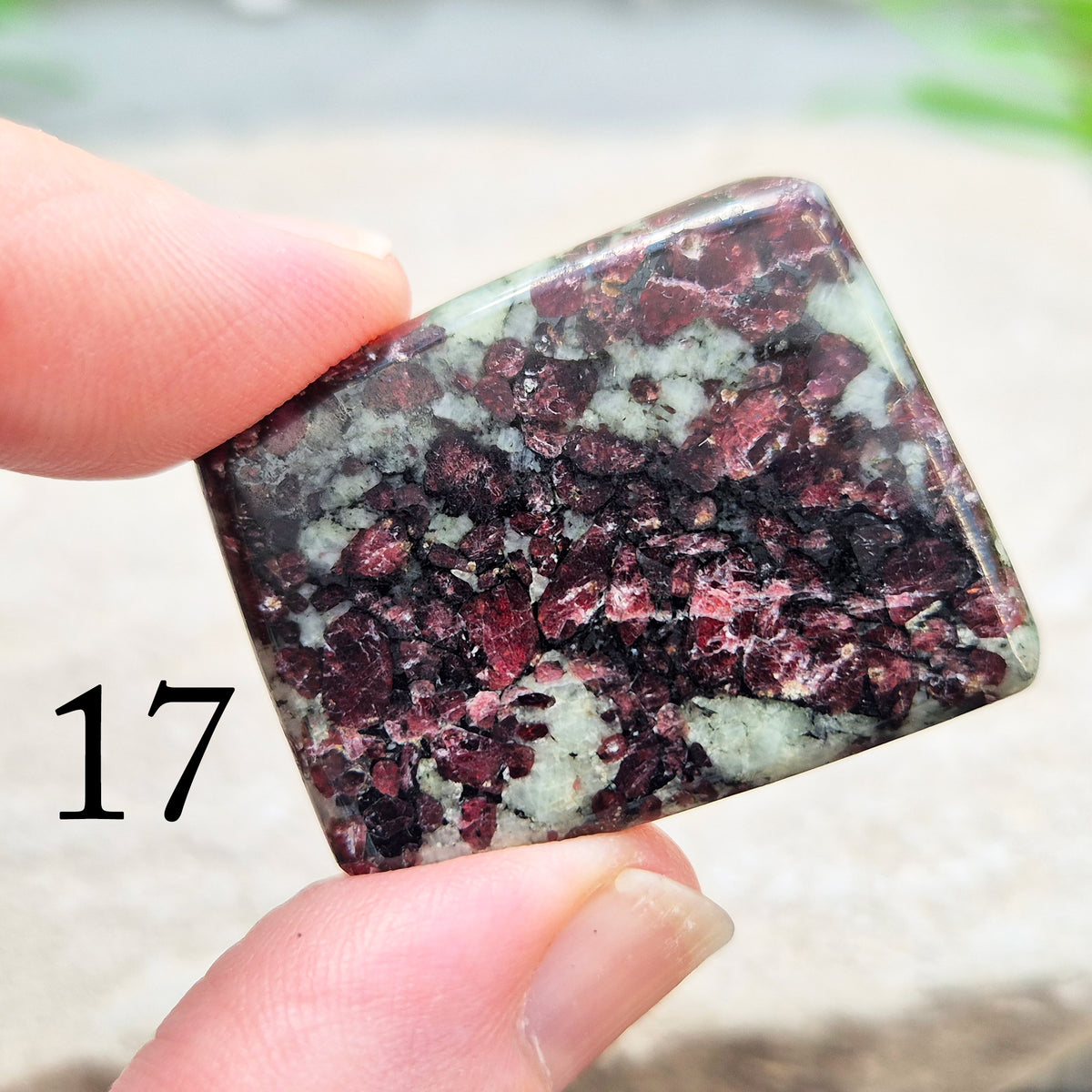 Hand-picked polished eudialyte slice with raspberry-pink and natural black and grey patterning. Often reached for heart-centred meditation.