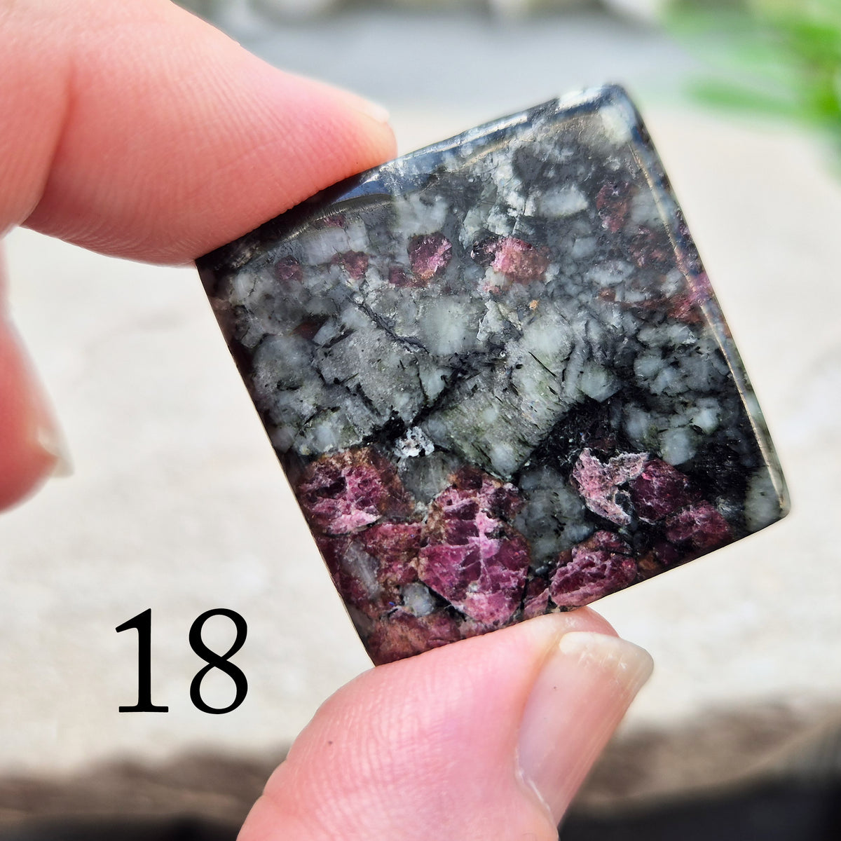 Hand-picked polished eudialyte slice with raspberry-pink and natural black and grey patterning. Often reached for heart-centred meditation.