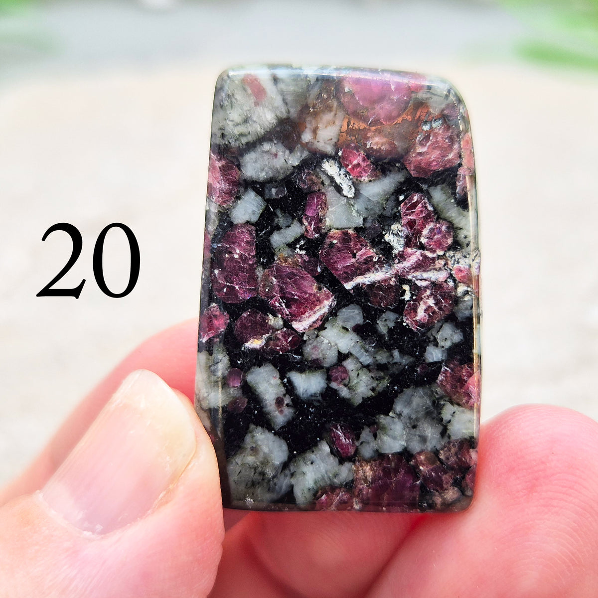 Hand-picked polished eudialyte slice with raspberry-pink and natural black and grey patterning. Often reached for heart-centred meditation.