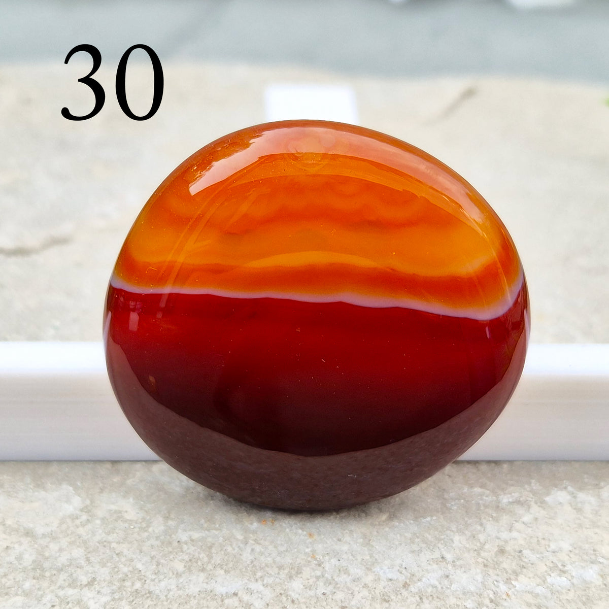 Banded Carnelian palm stone that is said to help Boost motivation, confidence and creativity. Grounding Root and Sacral crystal for energy and focus.