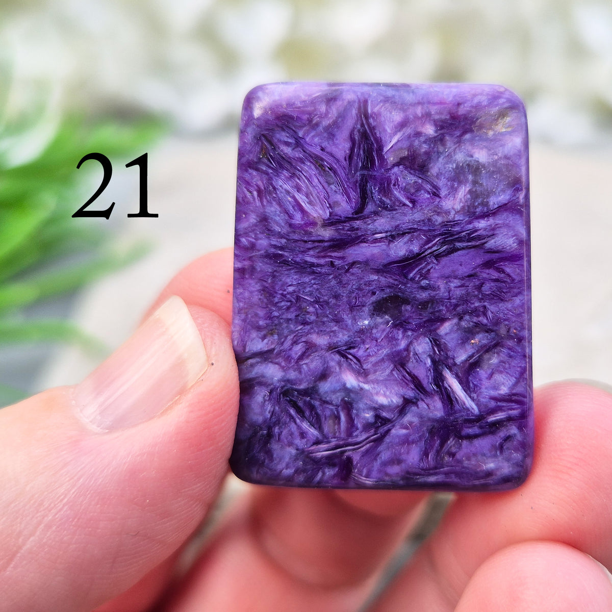 Polished Charoite slice with rich purple swirling patterns. A striking crystal associated with transformation, emotional strength, and personal growth. 