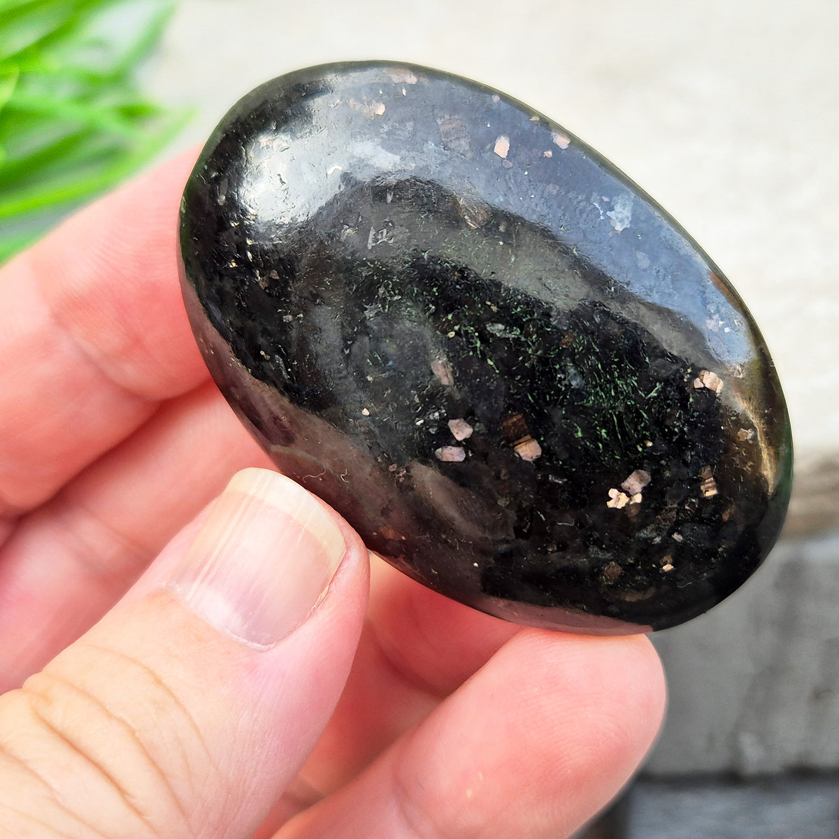Genuine Nuummite palm stone from Greenland, known as the Sorcerer's Stone. Often associated with protection, intuition, courage and clearing blockages.