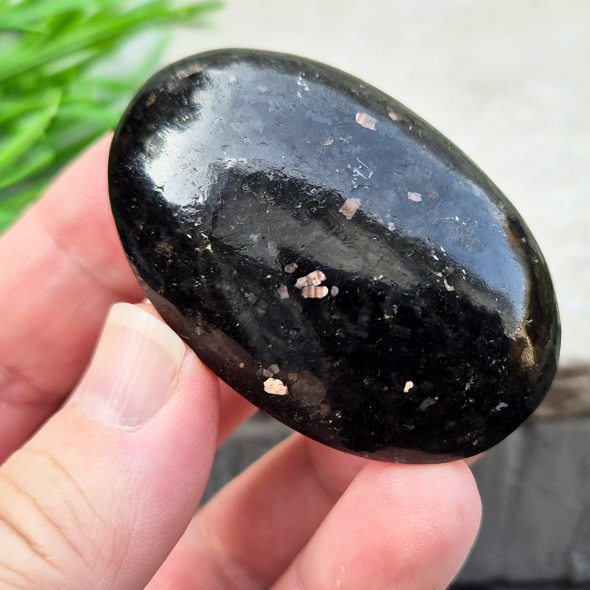 Genuine Nuummite palm stone from Greenland, known as the Sorcerer's Stone. Often associated with protection, intuition, courage and clearing blockages.