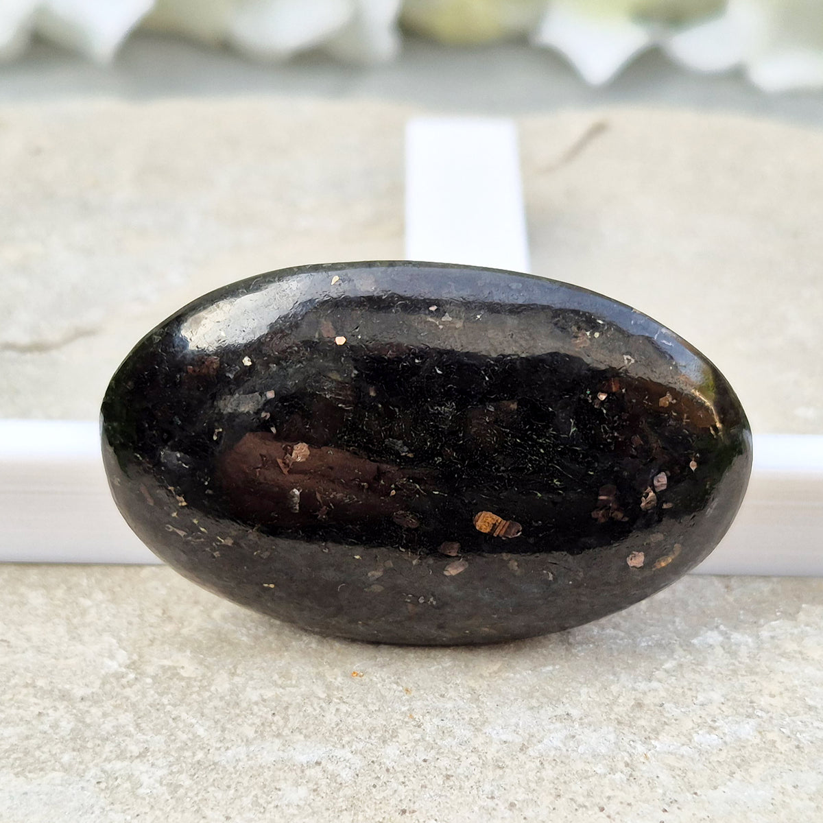 Genuine Nuummite palm stone from Greenland, known as the Sorcerer's Stone. Often associated with protection, intuition, courage and clearing blockages.