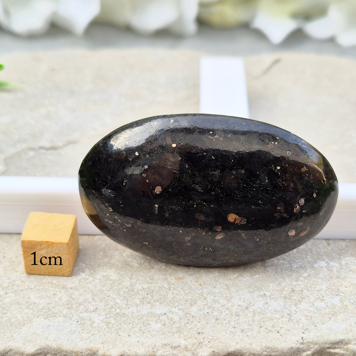 Genuine Nuummite palm stone from Greenland, known as the Sorcerer's Stone. Often associated with protection, intuition, courage and clearing blockages.
