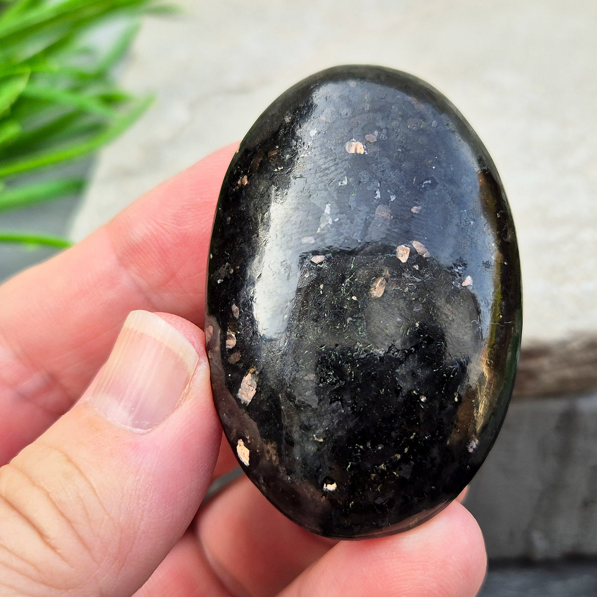 Genuine Nuummite palm stone from Greenland, known as the Sorcerer's Stone. Often associated with protection, intuition, courage and clearing blockages.
