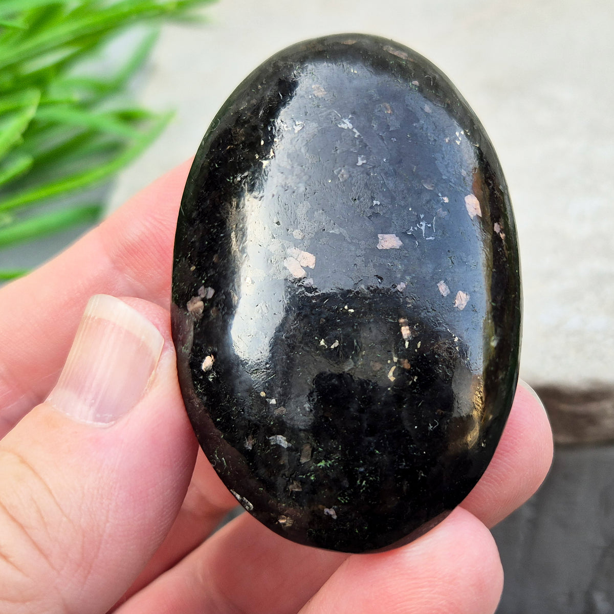 Genuine Nuummite palm stone from Greenland, known as the Sorcerer's Stone. Often associated with protection, intuition, courage and clearing blockages.