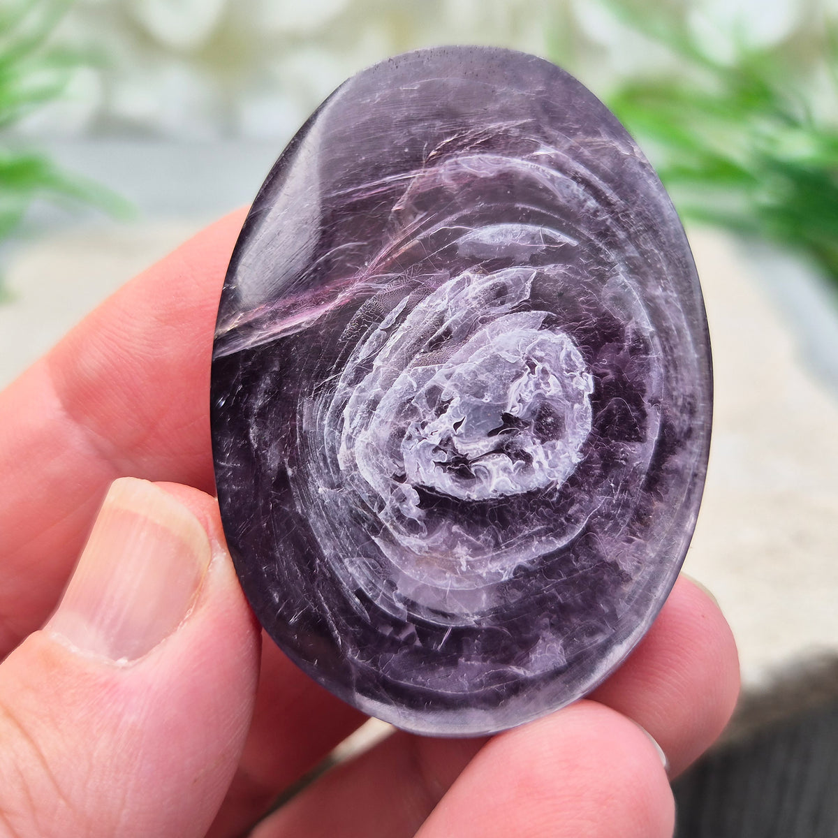 Metallic lilac Mica palm stone. Smooth, reflective, and grounding. Supports focus, calm emotions, and adds uplifting energy to any space.