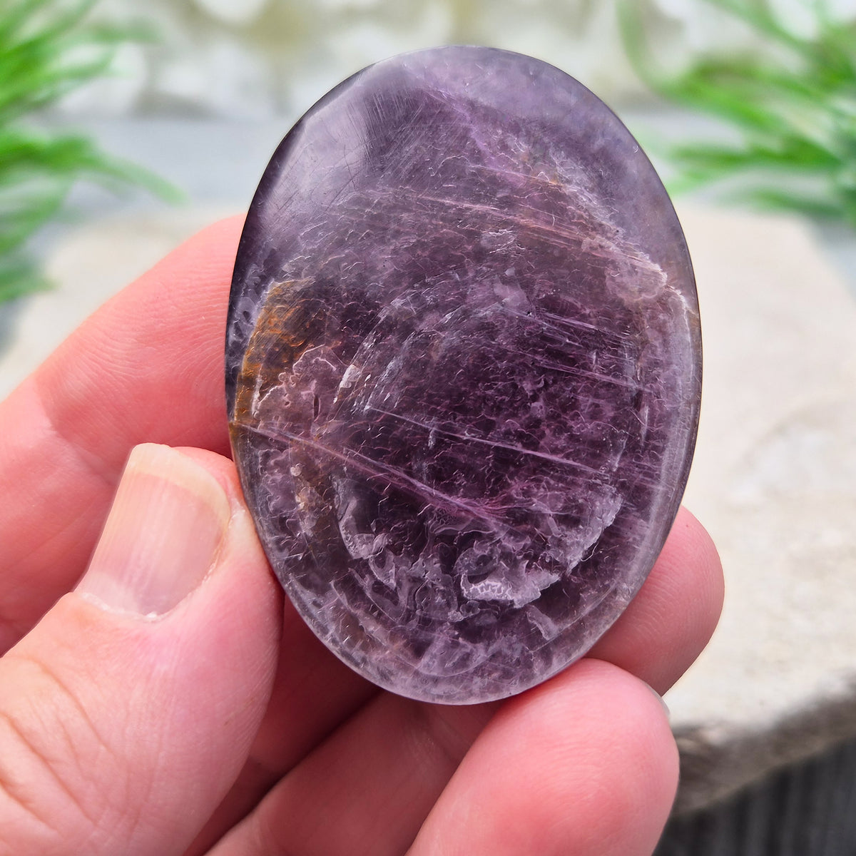 Metallic lilac Mica palm stone. Smooth, reflective, and grounding. Supports focus, calm emotions, and adds uplifting energy to any space.