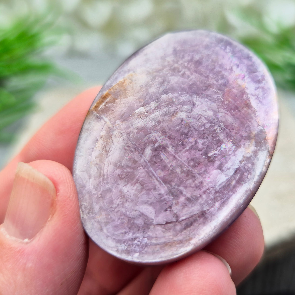 Metallic lilac Mica palm stone. Smooth, reflective, and grounding. Supports focus, calm emotions, and adds uplifting energy to any space.