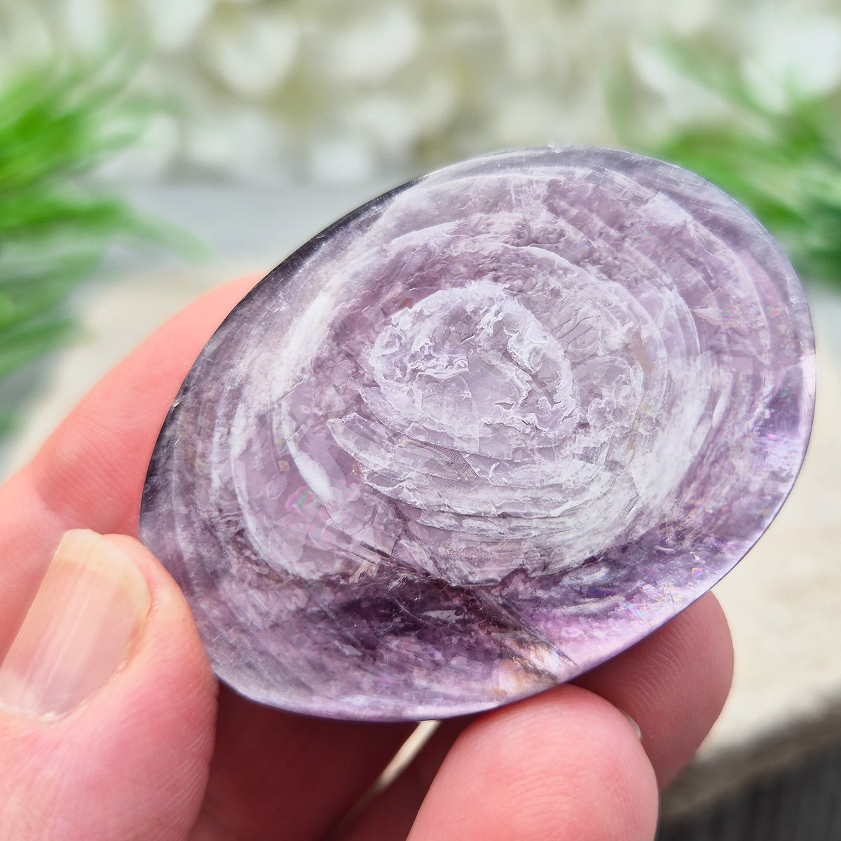 Metallic lilac Mica palm stone. Smooth, reflective, and grounding. Supports focus, calm emotions, and adds uplifting energy to any space.