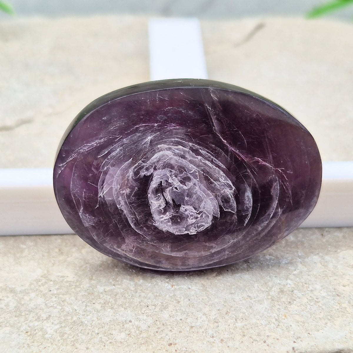 Metallic lilac Mica palm stone. Smooth, reflective, and grounding. Supports focus, calm emotions, and adds uplifting energy to any space.