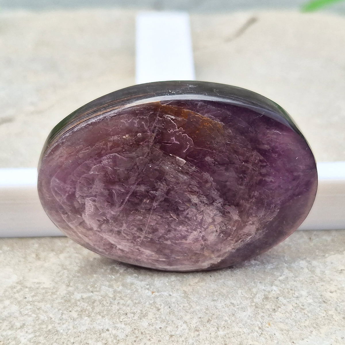 Metallic lilac Mica palm stone. Smooth, reflective, and grounding. Supports focus, calm emotions, and adds uplifting energy to any space.