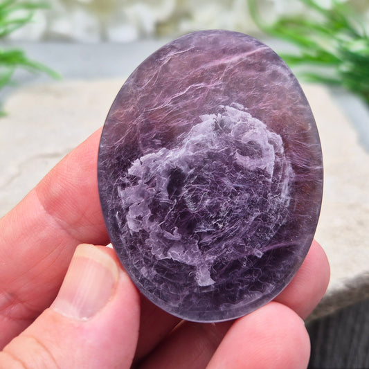 Mica palm stone in shimmering metallic lilac. Perfect for holding, mindful energy, and gifting. Helps steady thoughts, balance emotions, and uplift.
