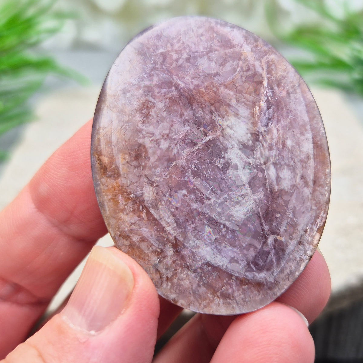 Mica palm stone in shimmering metallic lilac. Perfect for holding, mindful energy, and gifting. Helps steady thoughts, balance emotions, and uplift.
