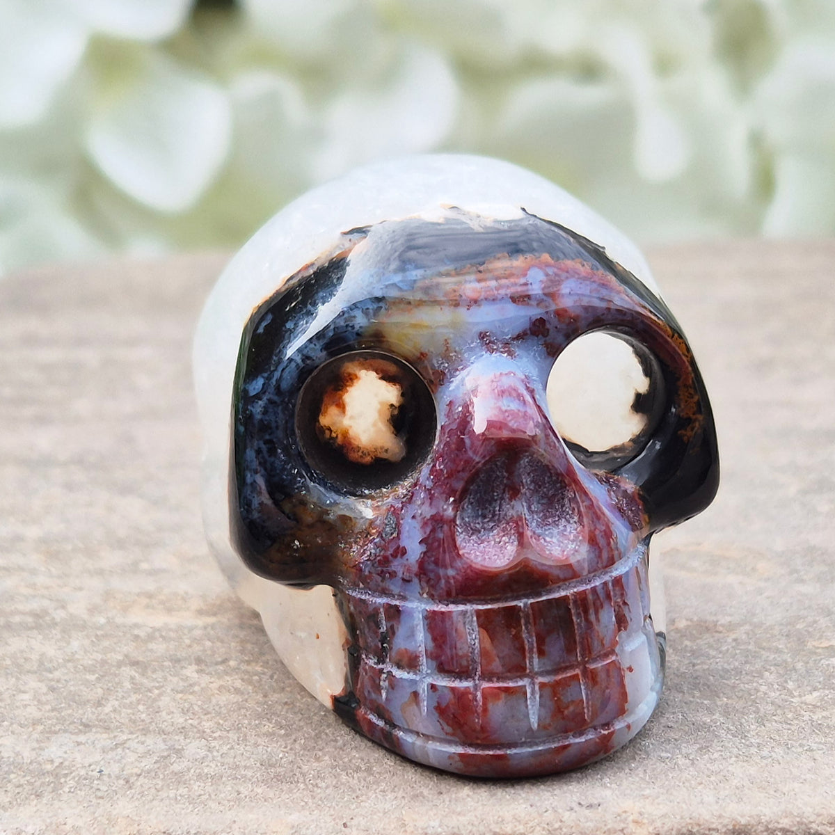 Polished Sardonyx crystal skull. Grounding stone for strength, discipline and protection. Supports focus, stability and confident decision-making.