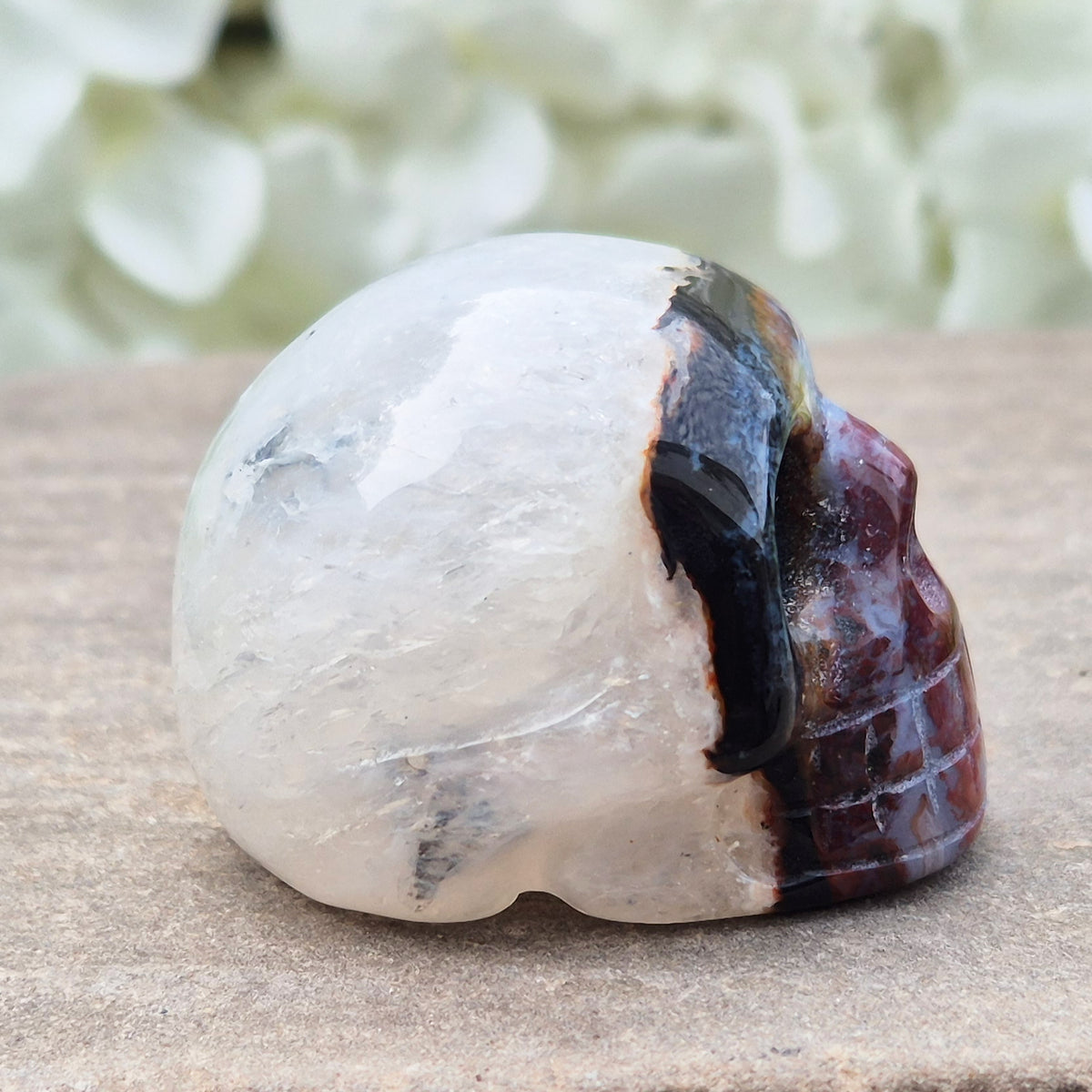 Polished Sardonyx crystal skull. Grounding stone for strength, discipline and protection. Supports focus, stability and confident decision-making.