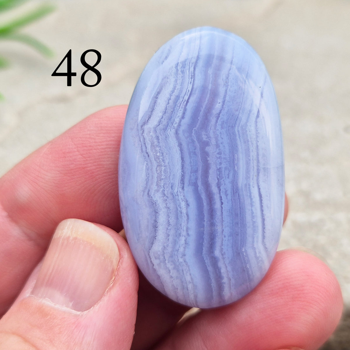Polished Blue Lace Agate crystal palm stone with wonderful banding. A calming crystal, ideal for relaxation, clear communication and gentle healing. 