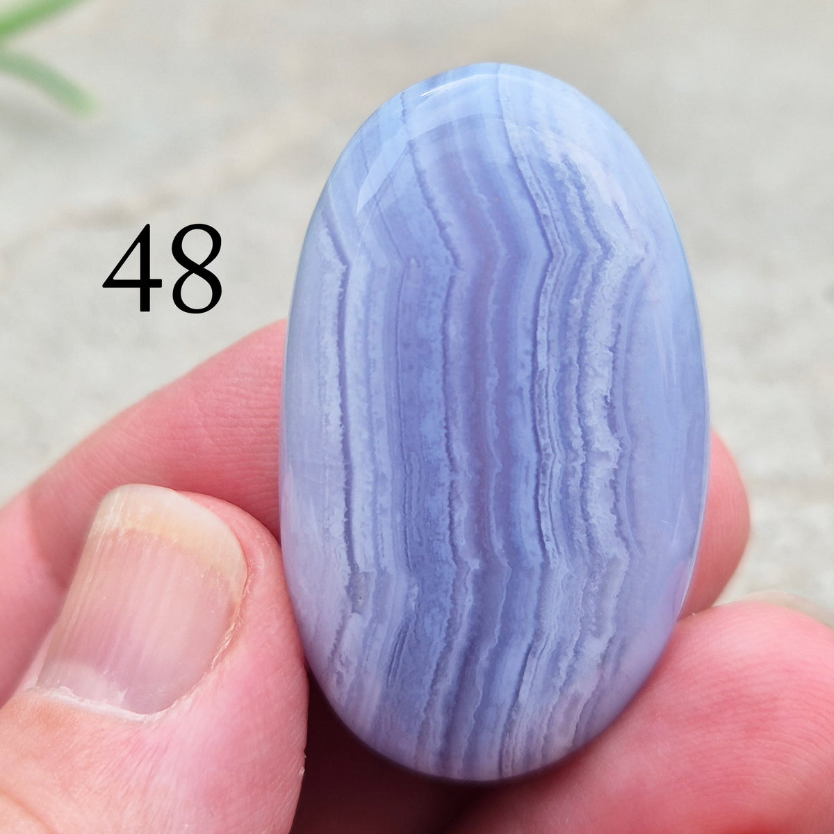 Polished Blue Lace Agate crystal palm stone with wonderful banding. A calming crystal, ideal for relaxation, clear communication and gentle healing. 