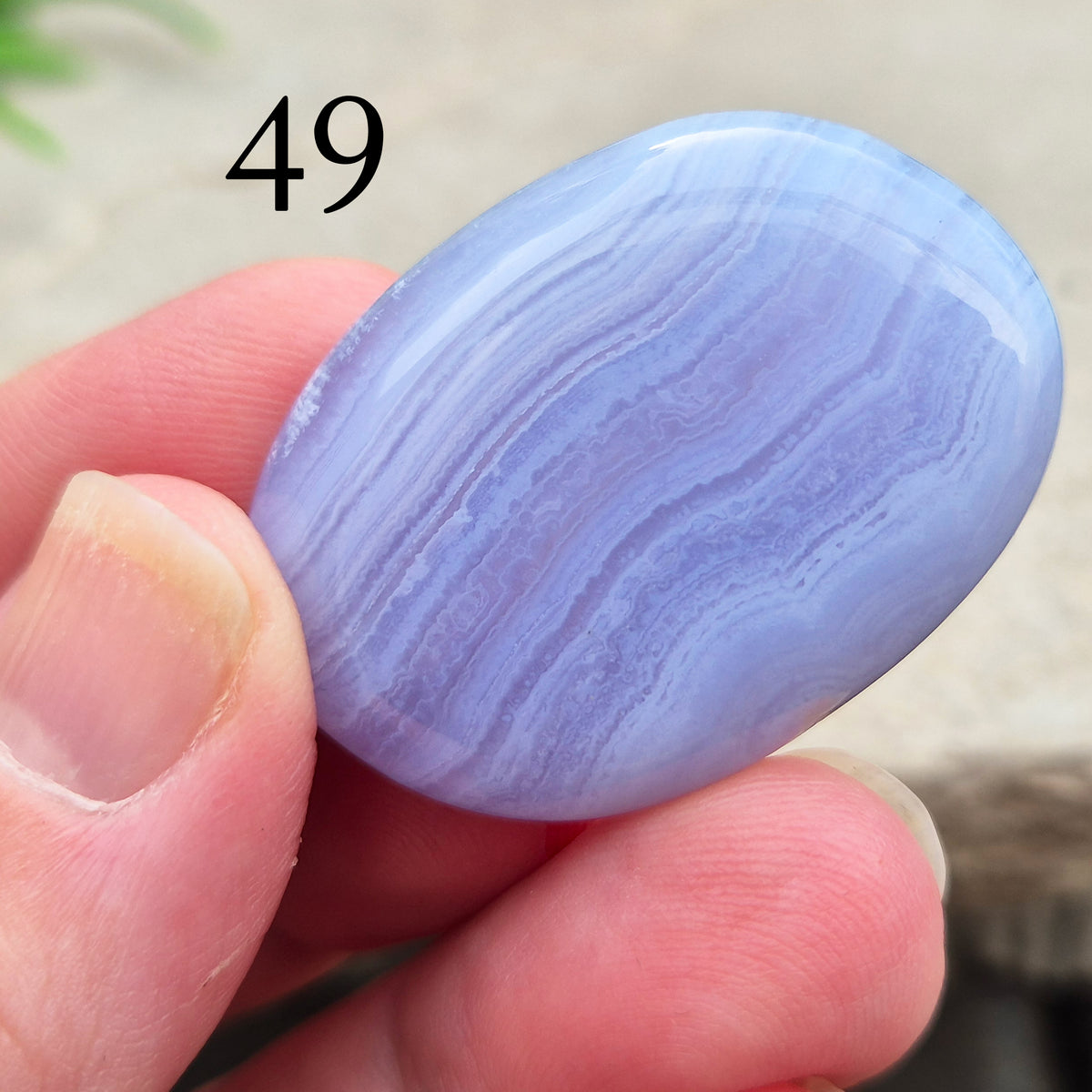 Polished Blue Lace Agate crystal palm stone with wonderful banding. A calming crystal, ideal for relaxation, clear communication and gentle healing. 