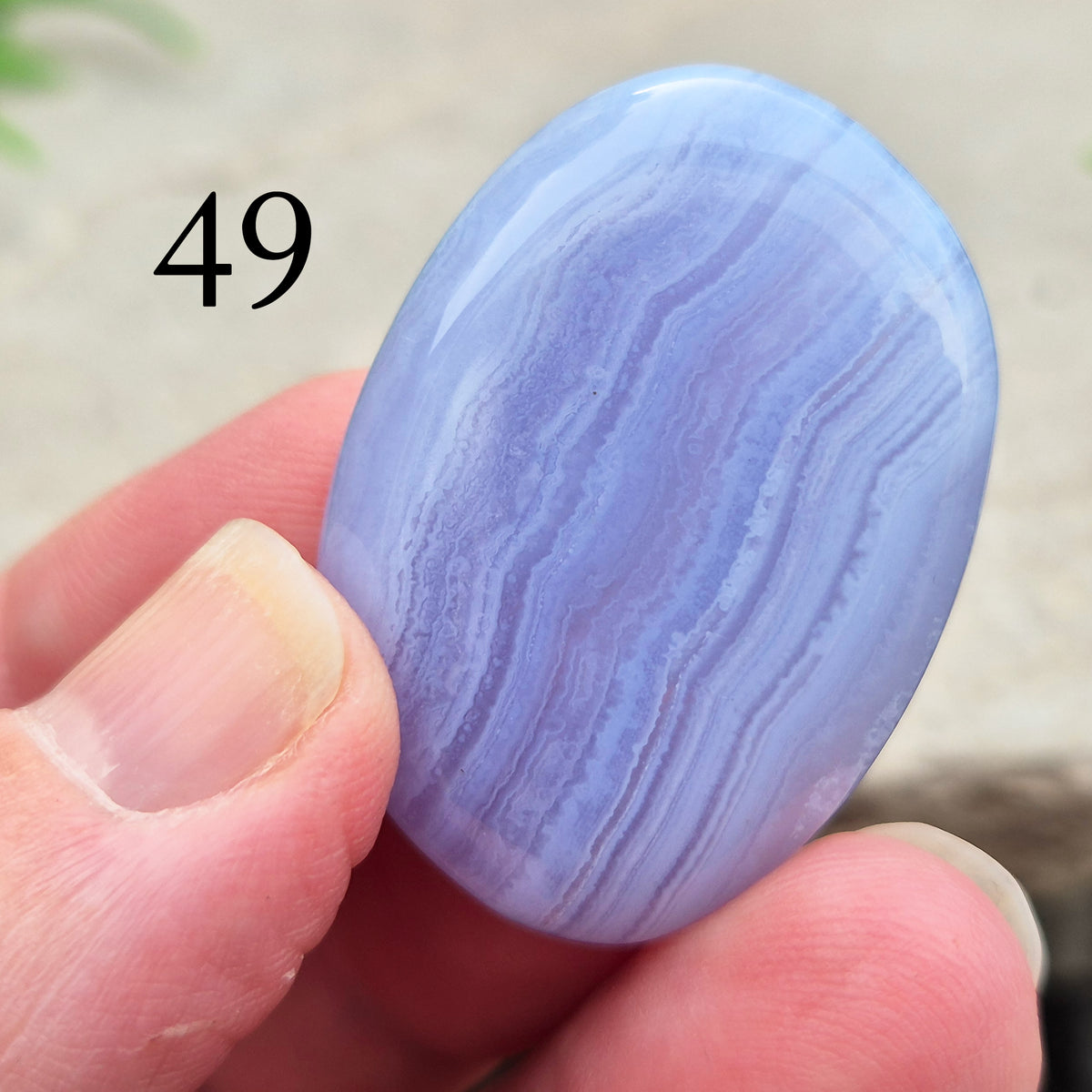 Polished Blue Lace Agate crystal palm stone with wonderful banding. A calming crystal, ideal for relaxation, clear communication and gentle healing. 