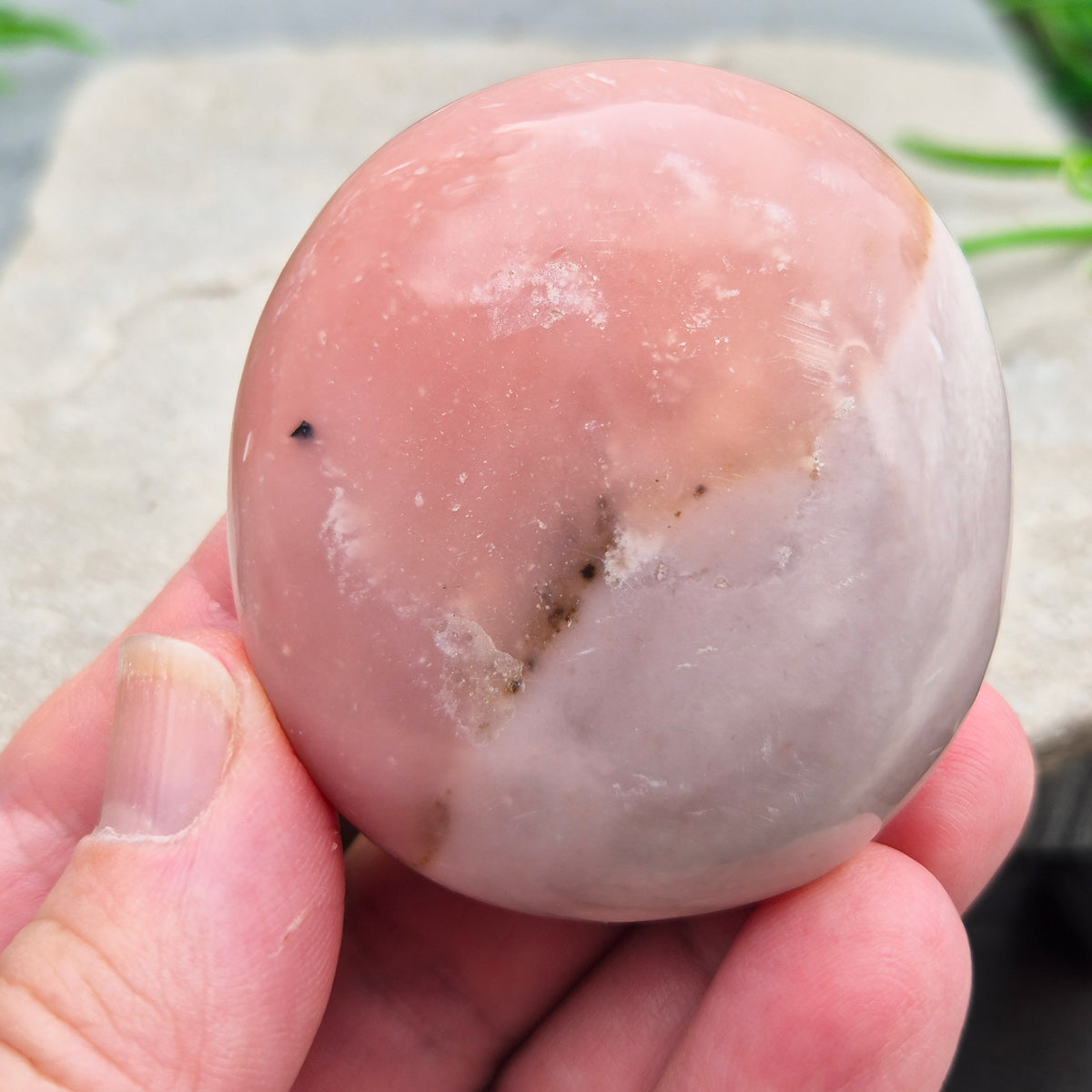 Pink Opal palm stone from Peru with soft pink to salmon tones and a glossy polish. A gentle heart chakra crystal for grief, heartbreak and emotional healing.