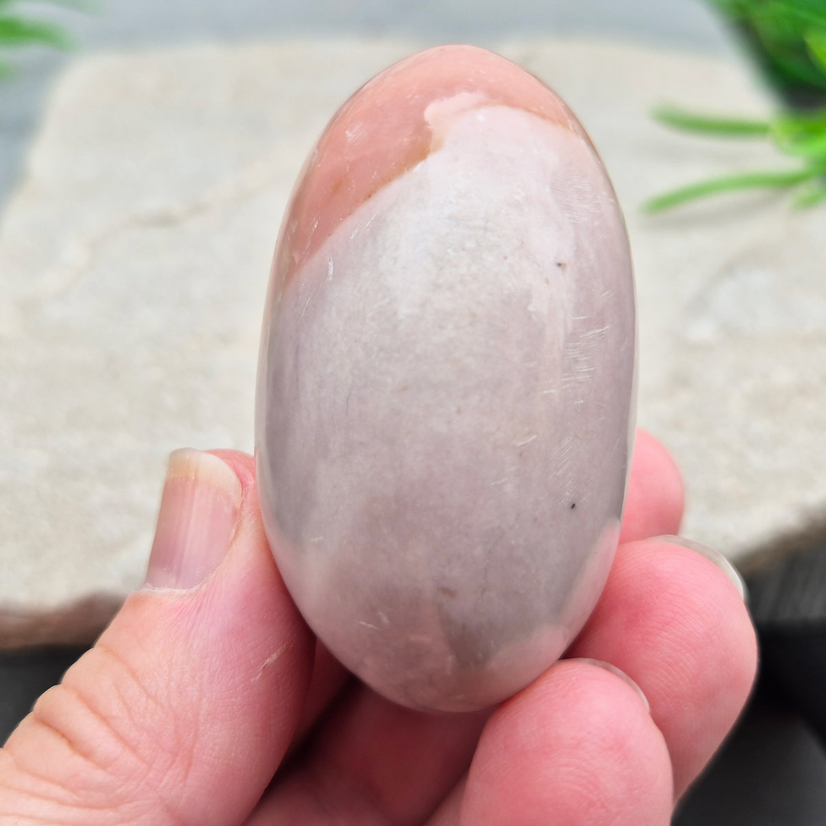 Pink Opal palm stone from Peru with soft pink to salmon tones and a glossy polish. A gentle heart chakra crystal for grief, heartbreak and emotional healing.