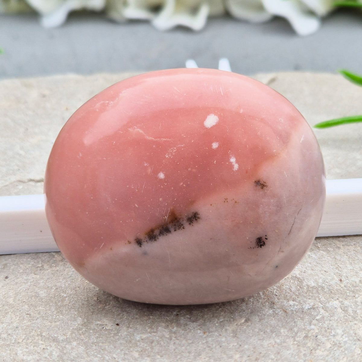 Pink Opal palm stone from Peru with soft pink to salmon tones and a glossy polish. A gentle heart chakra crystal for grief, heartbreak and emotional healing.