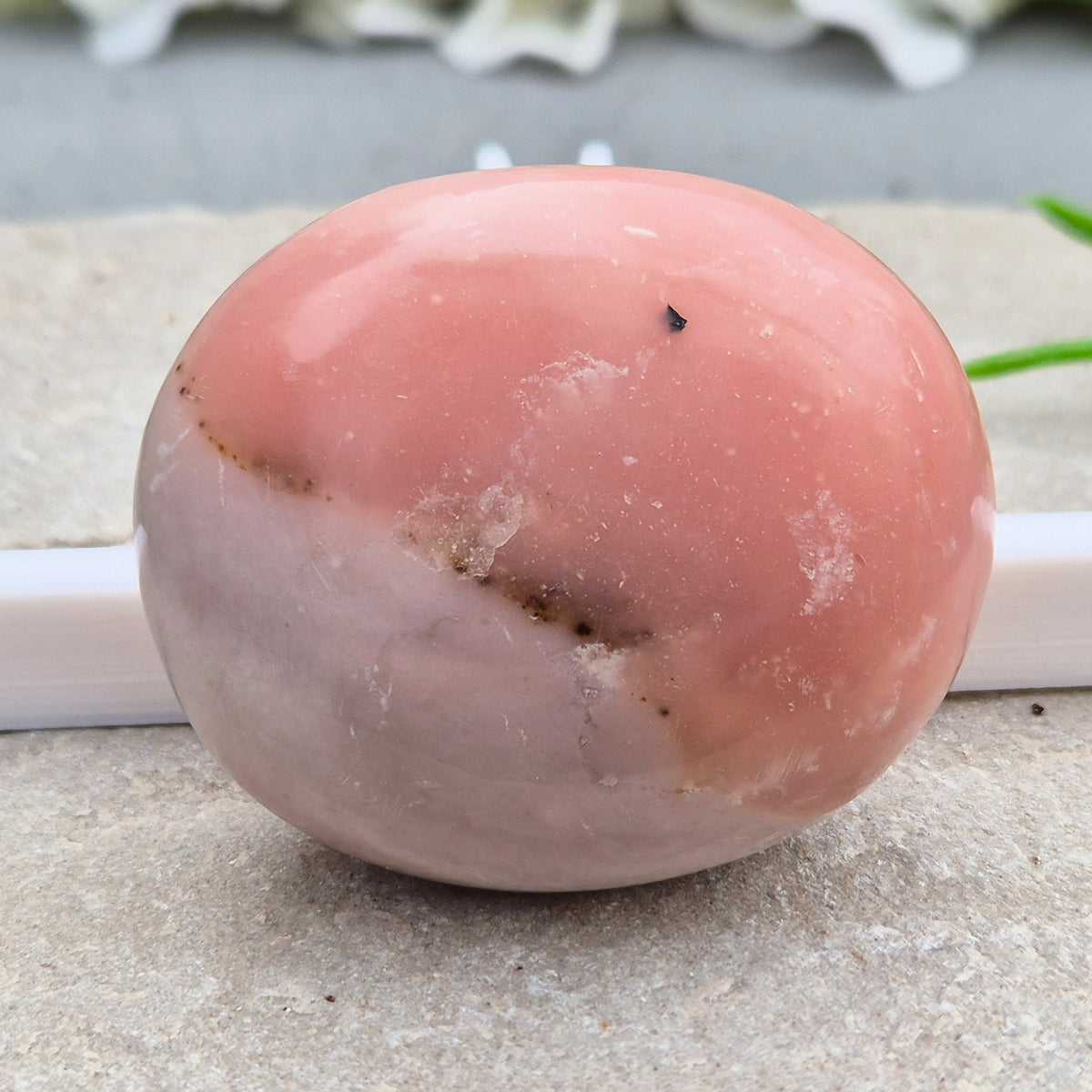 Pink Opal palm stone from Peru with soft pink to salmon tones and a glossy polish. A gentle heart chakra crystal for grief, heartbreak and emotional healing.