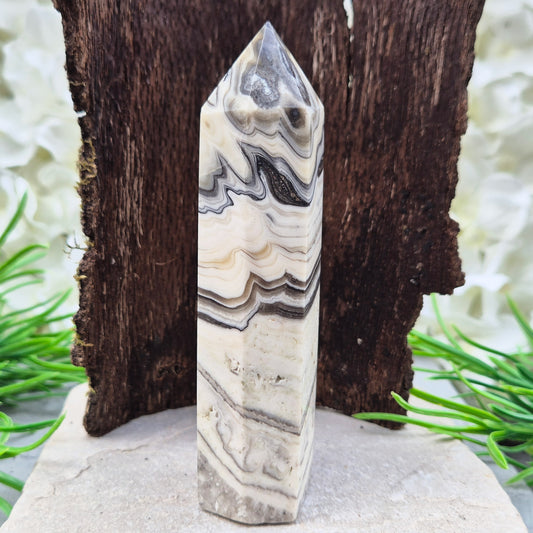 Zebra Calcite Point – Encourages self-awareness, clarity, and calm. A powerful tool for growth, balance, and emotional strength.
