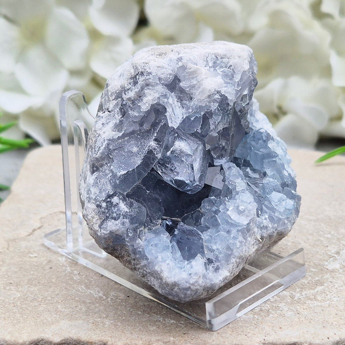 Celestite cluster from Madagascar. A calming, uplifting crystal for peace, creativity, spiritual connection, and angelic guidance. Comes with a stand.