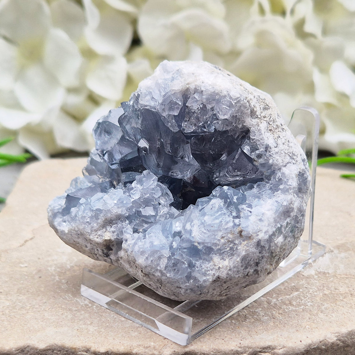 Celestite cluster from Madagascar. A calming, uplifting crystal for peace, creativity, spiritual connection, and angelic guidance. Comes with a stand.