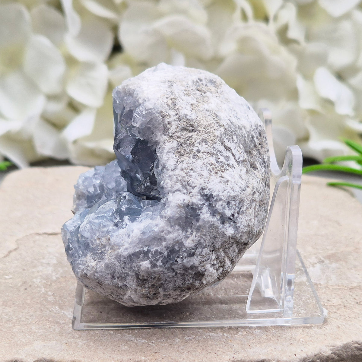 Celestite cluster from Madagascar. A calming, uplifting crystal for peace, creativity, spiritual connection, and angelic guidance. Comes with a stand.