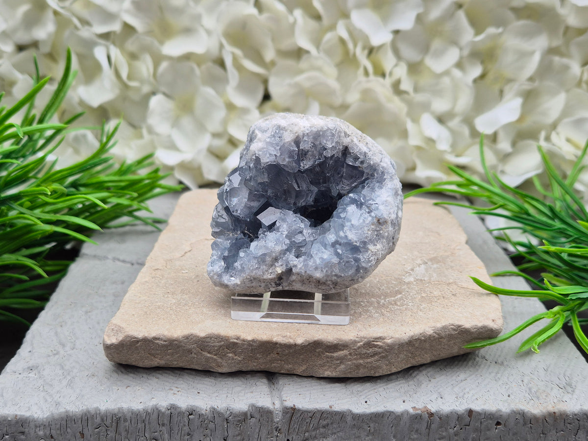 Celestite cluster from Madagascar. A calming, uplifting crystal for peace, creativity, spiritual connection, and angelic guidance. Comes with a stand.
