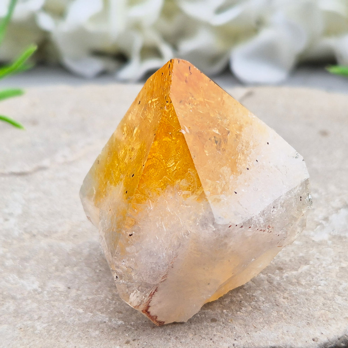 Citrine crystal standing point from Brazil with a polished tip and natural sides. Associated with confidence, motivation, positivity, and personal growth.